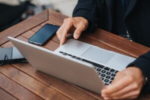 Remote tech workers collaborating on laptops in a modern workspace