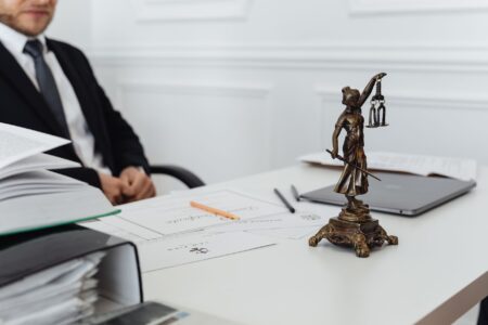 Attorney reviewing legal documents at a desk, representing small law firm research workflow
