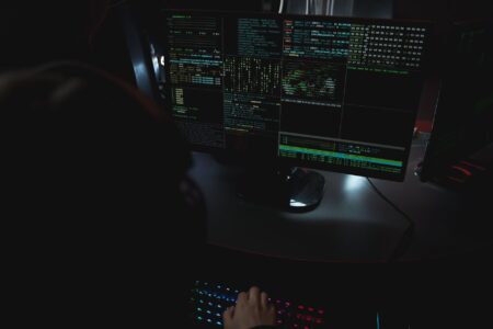A developer working at a computer with a terminal window open on screen