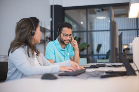 Intercom’s AI Agent Push Is Cornering Zendesk’s Mid-Market Base A customer support representative working at a computer in a modern office environment