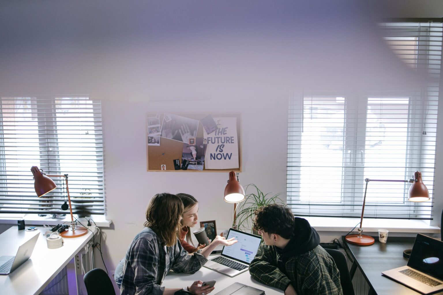 Dust’s Enterprise AI Platform Is Peeling Clients from Microsoft Copilot Enterprise team collaborating around a laptop in a modern office setting