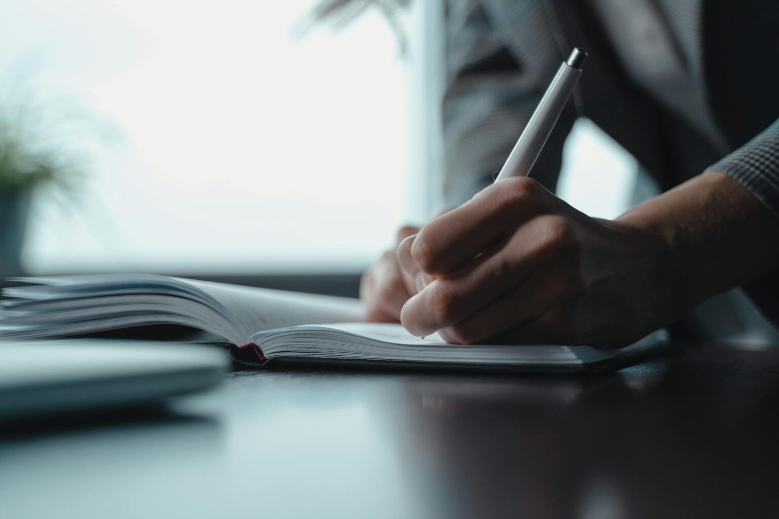 Hebbia’s AI Research Tool Is Pulling Associates from Bloomberg Law Legal associate at desk surrounded by documents and computer screens doing research