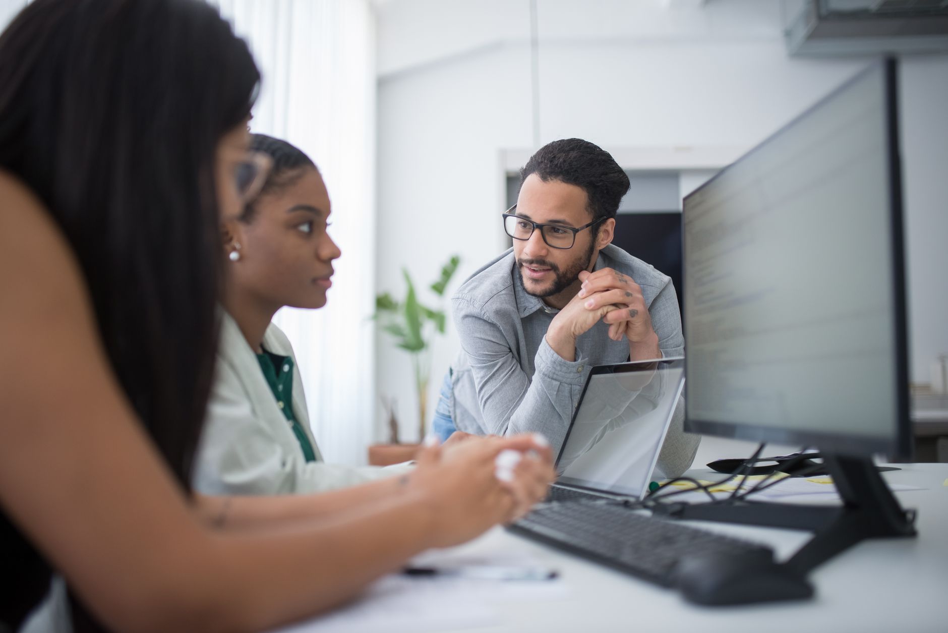 Team reviewing software tools on screens during an enterprise technology meeting