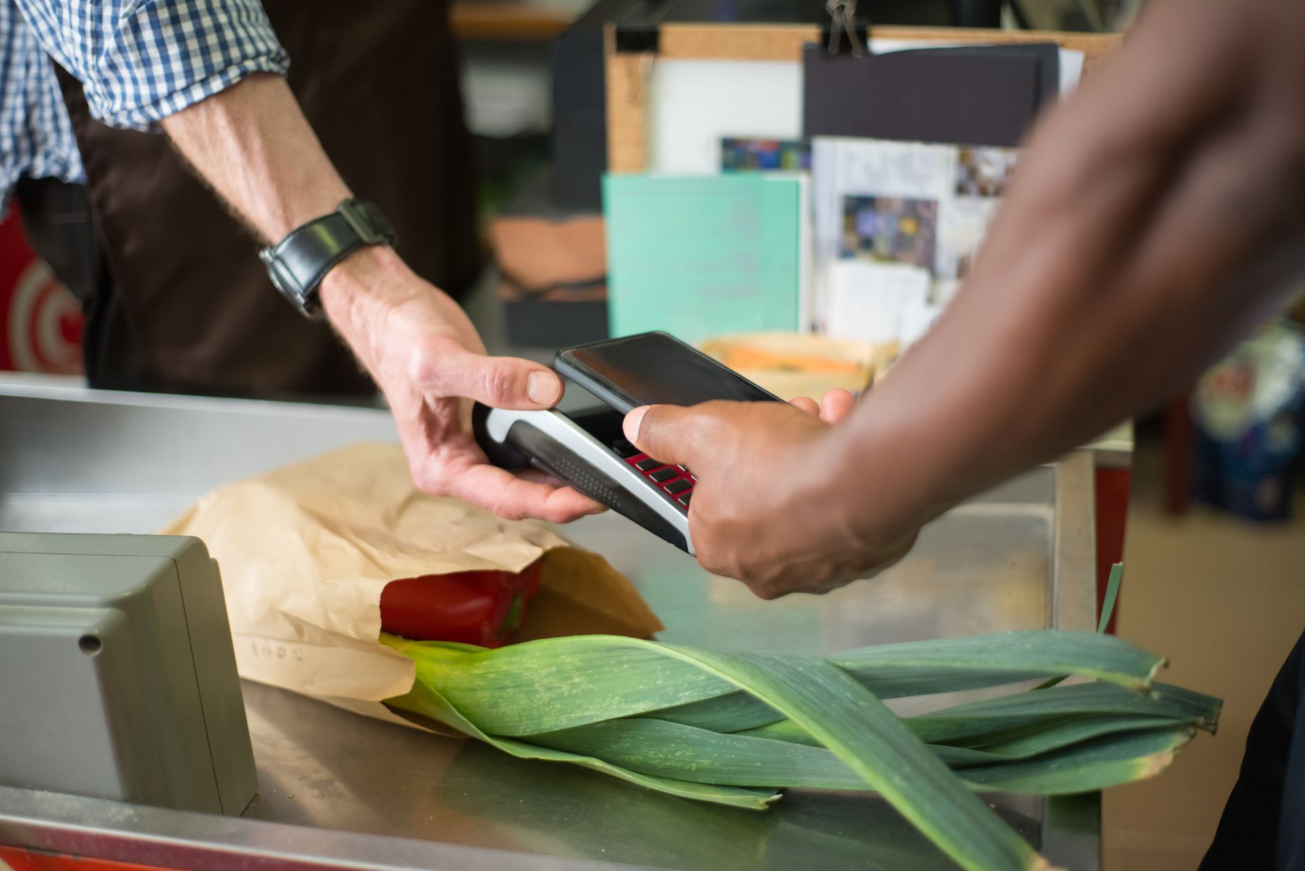 Consumer making a payment at a retail checkout counter