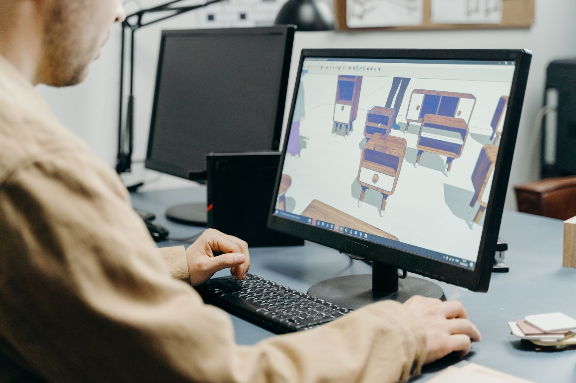 Designer working on a large digital display with graphic design software open