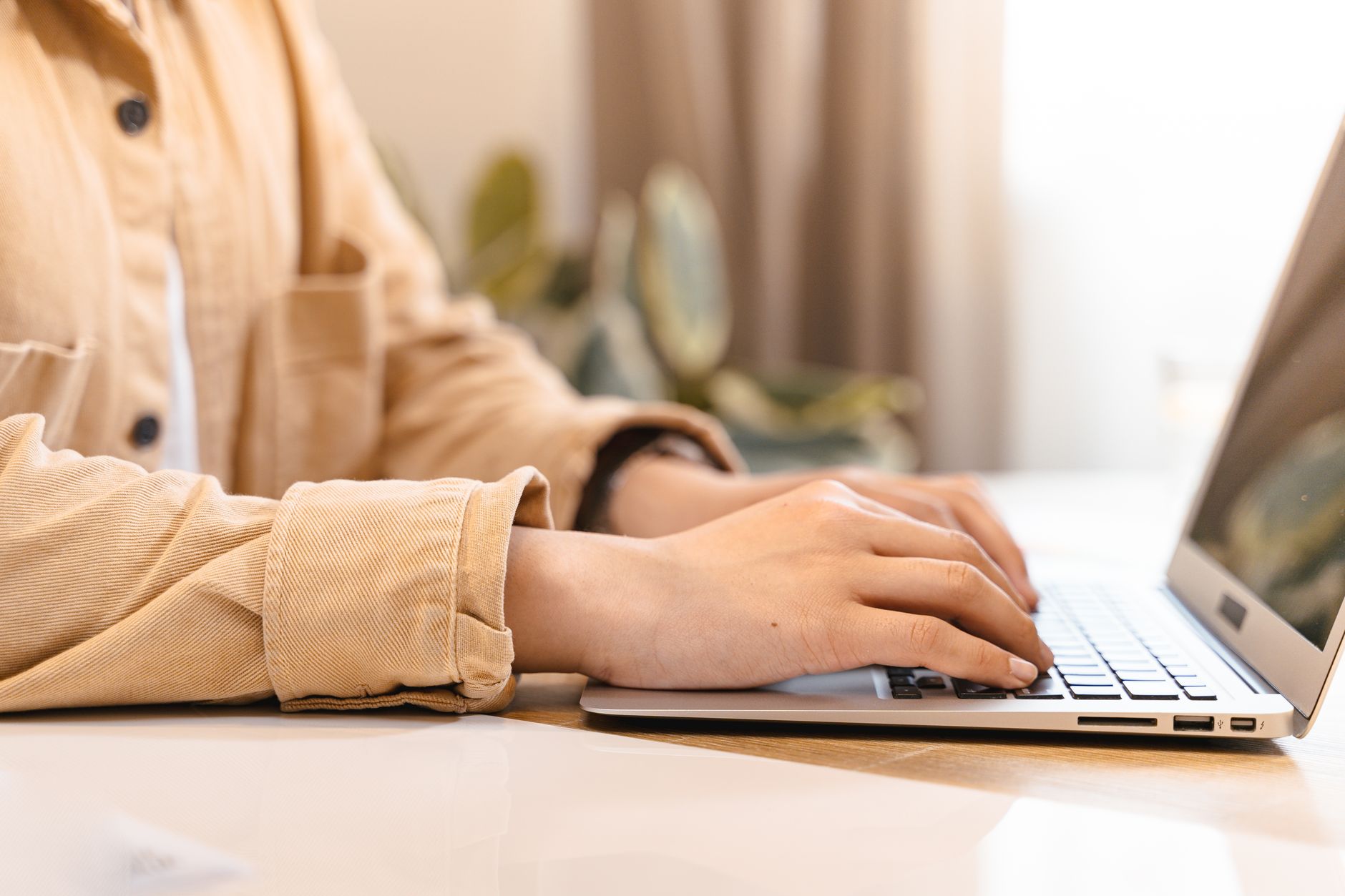 A person working on a laptop, representing productivity software and dictation workflows