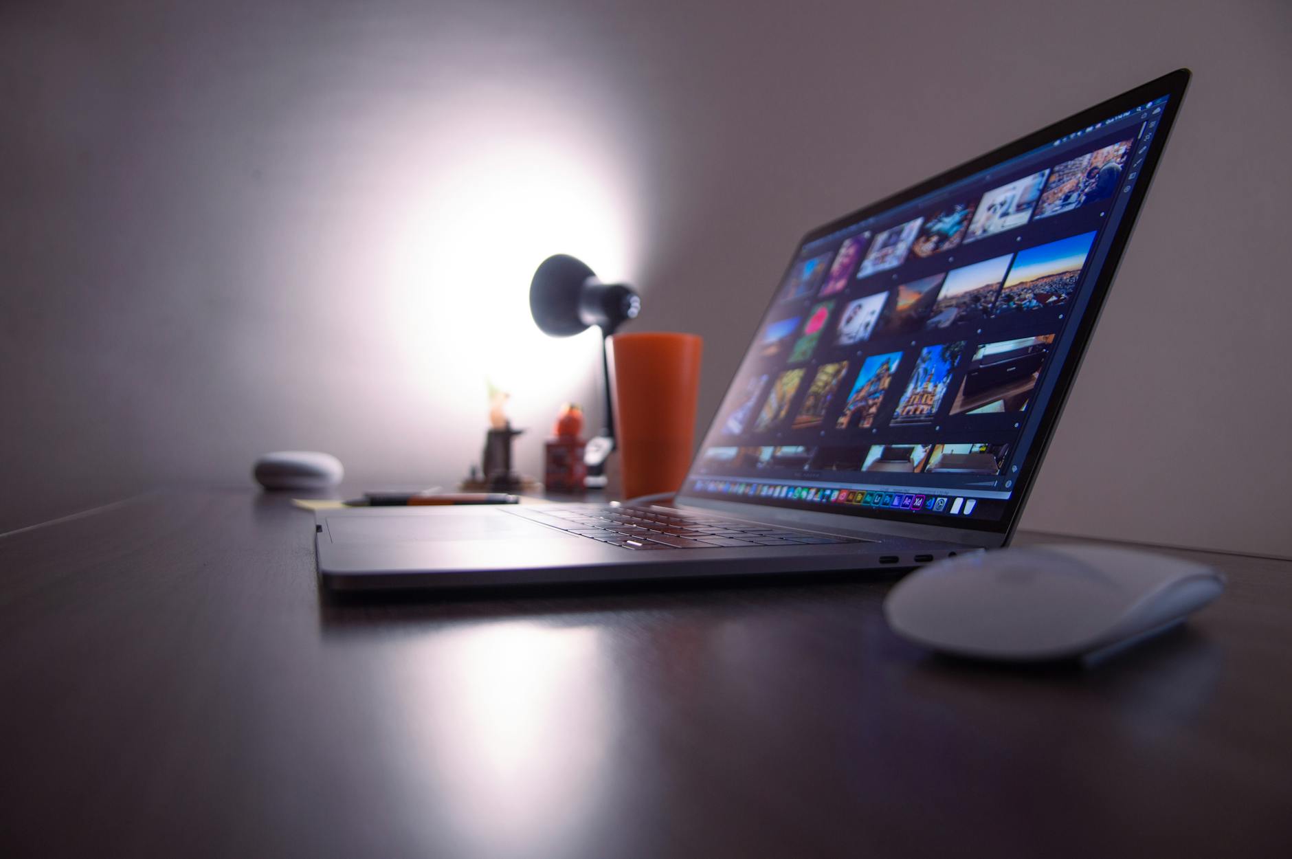 A designer working on a visual document layout on a large monitor