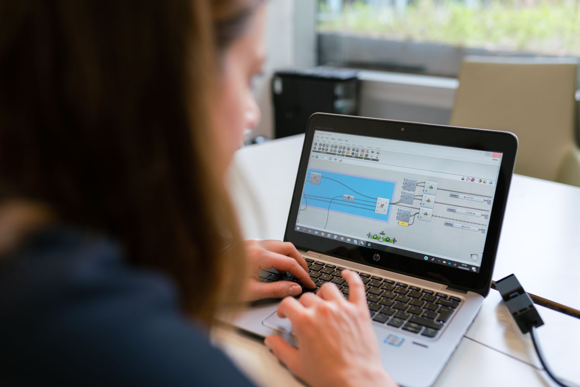 A person working on business software on a laptop at a desk
