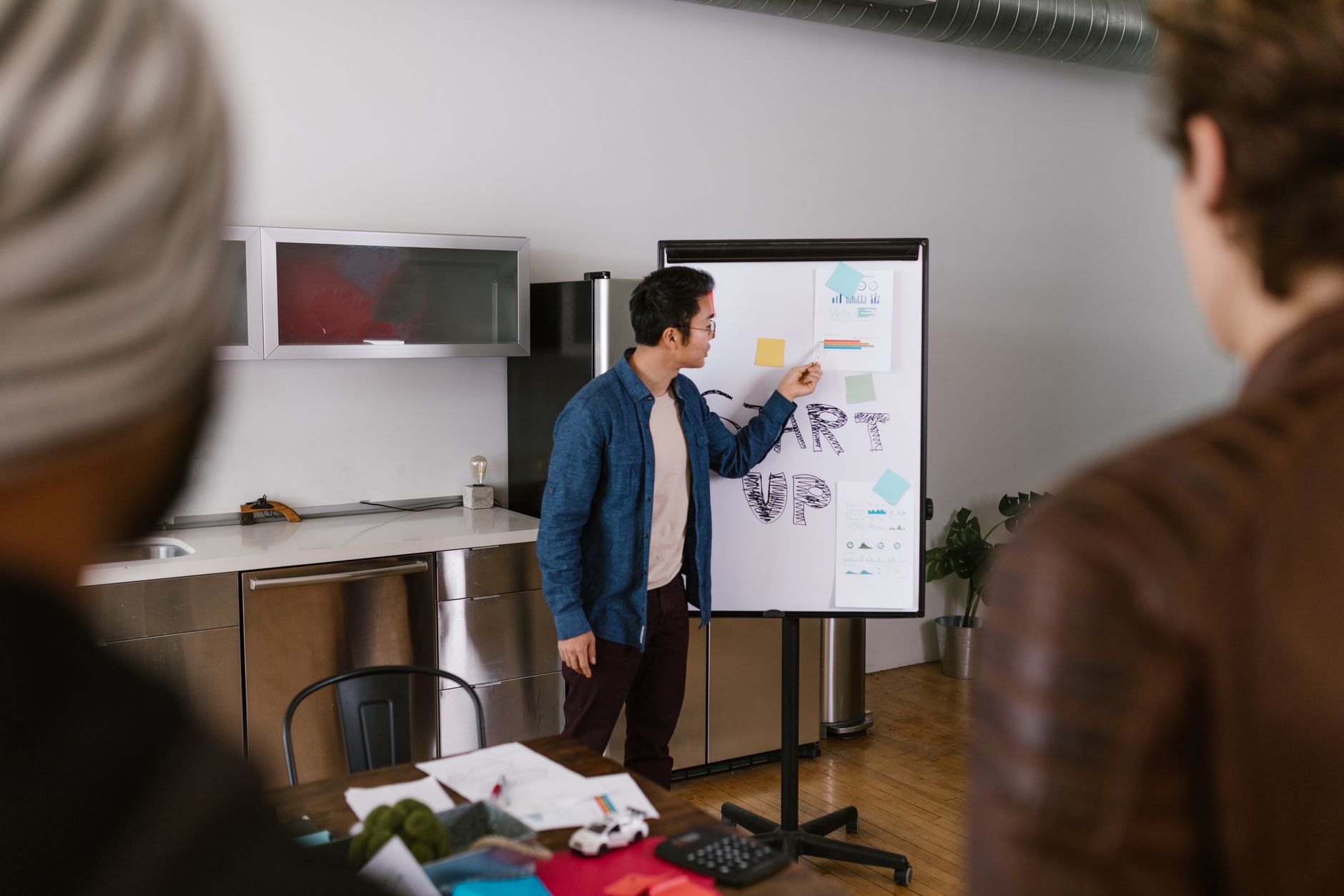 A small startup team collaborating around a table in a modern workspace