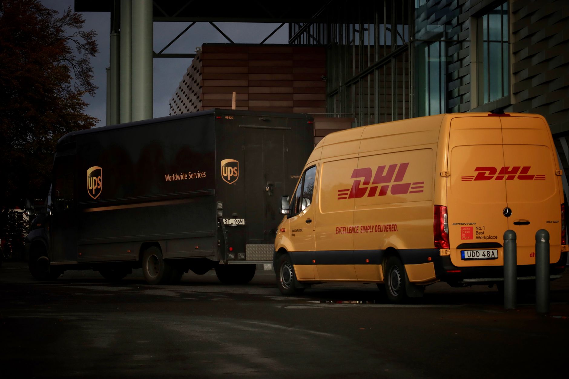 Commercial delivery fleet vehicles lined up in a logistics yard