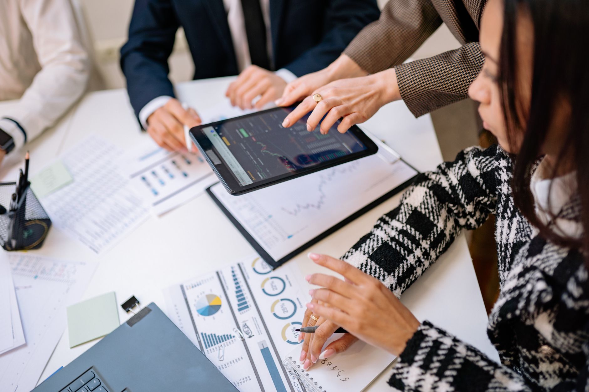 Small business team reviewing workflow tools together at a conference table