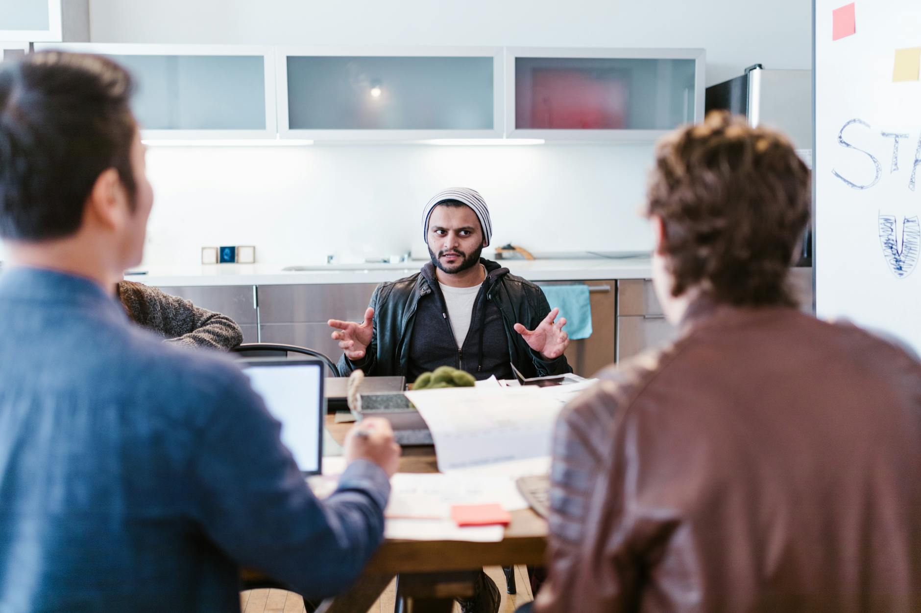 Small team gathered around a table in an open office environment