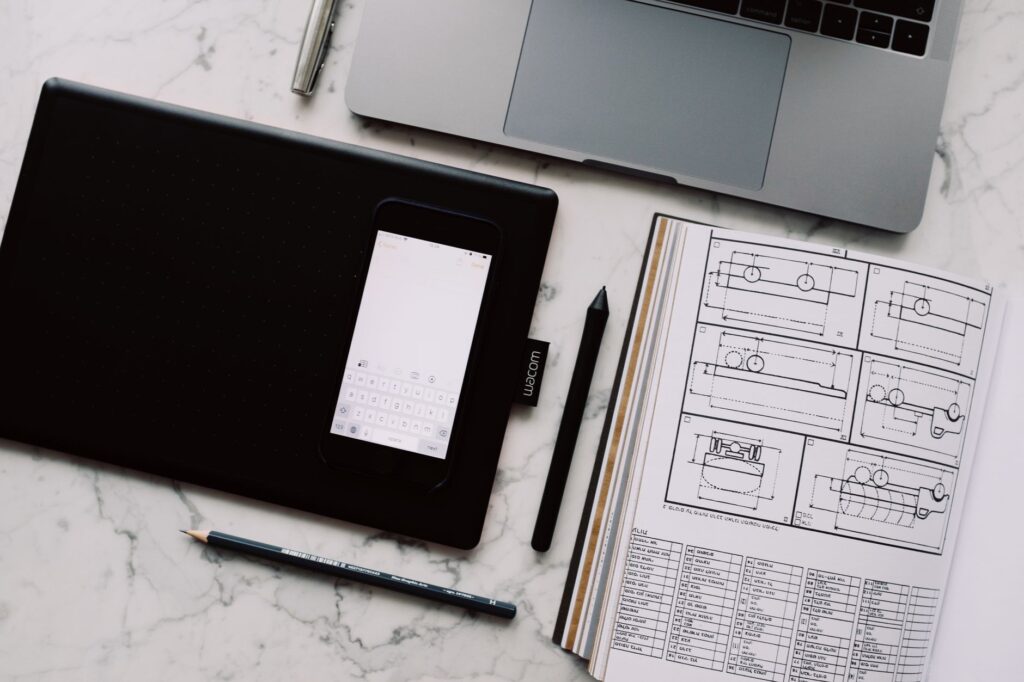 Ideogram’s Design Tools Are Pulling Brands Away from Canva’s AI Suite A designer working at a laptop in a creative workspace, representing digital design tool workflows