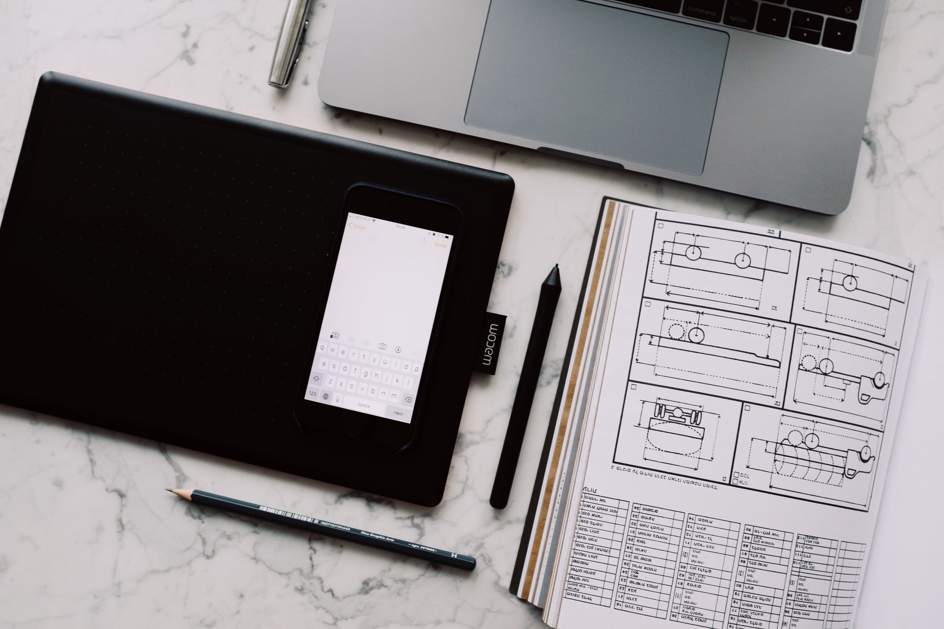 A designer working at a laptop in a creative workspace, representing digital design tool workflows
