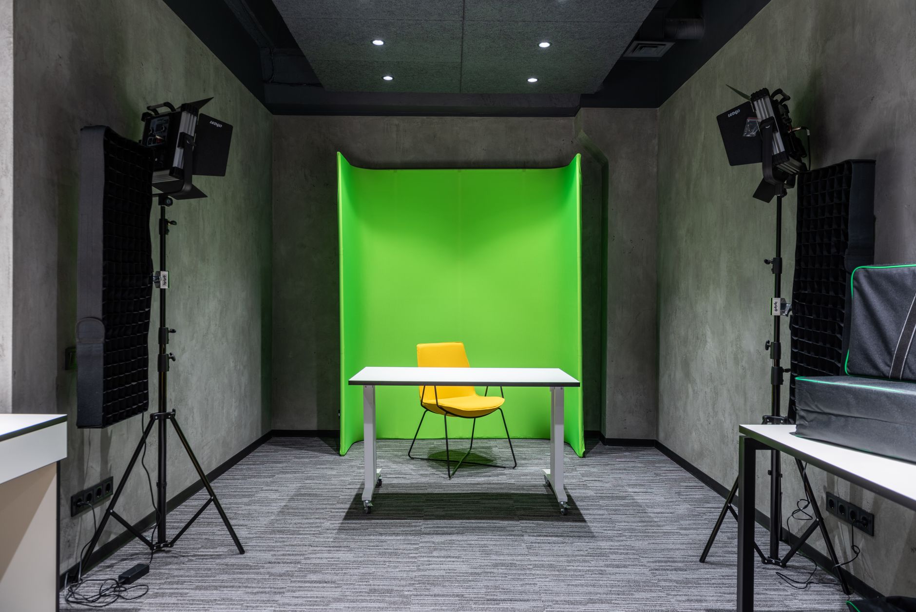 A modern video production studio with screens displaying digital editing software