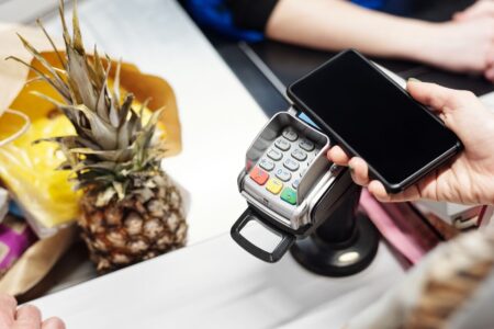 Person completing a purchase on a smartphone checkout screen