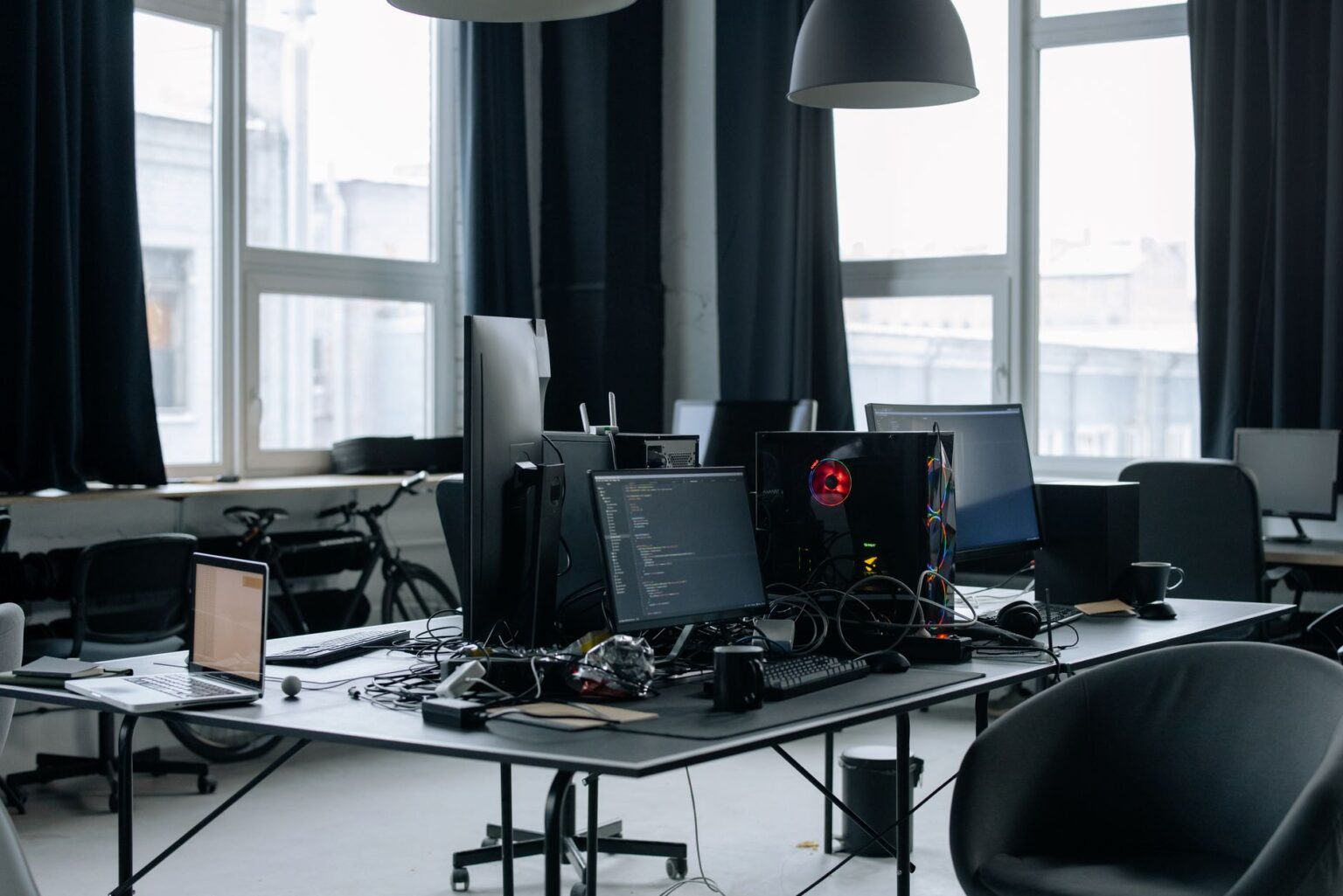 Developer working at a dual-monitor desk with code on screen