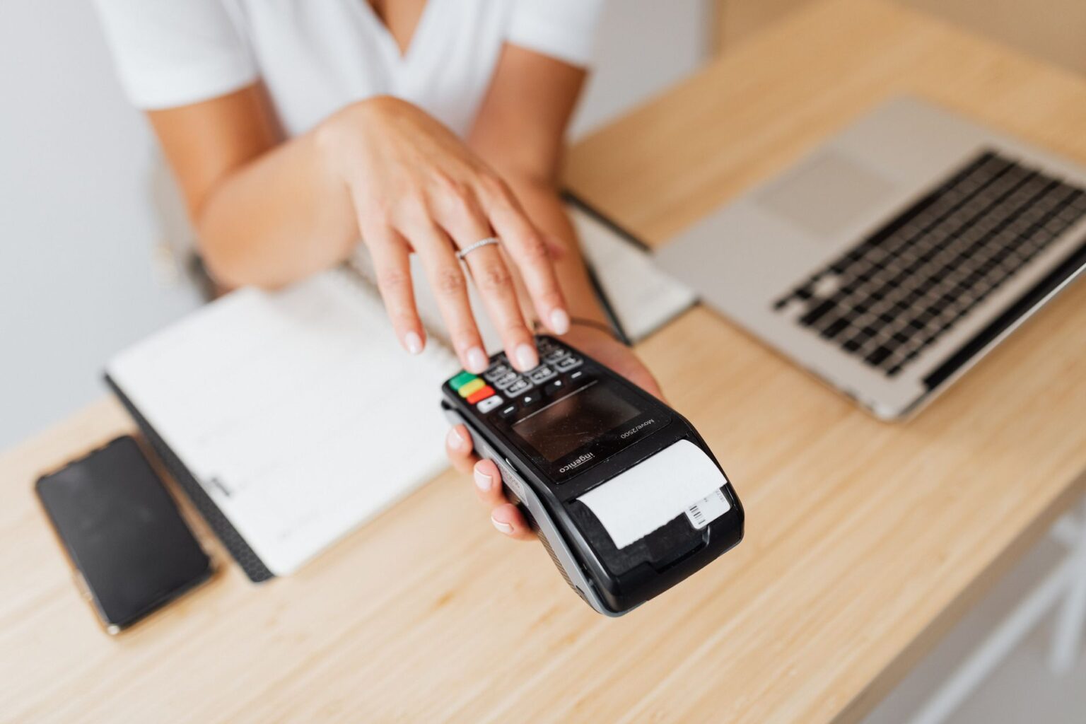 A person using a laptop to manage business payments and invoices online