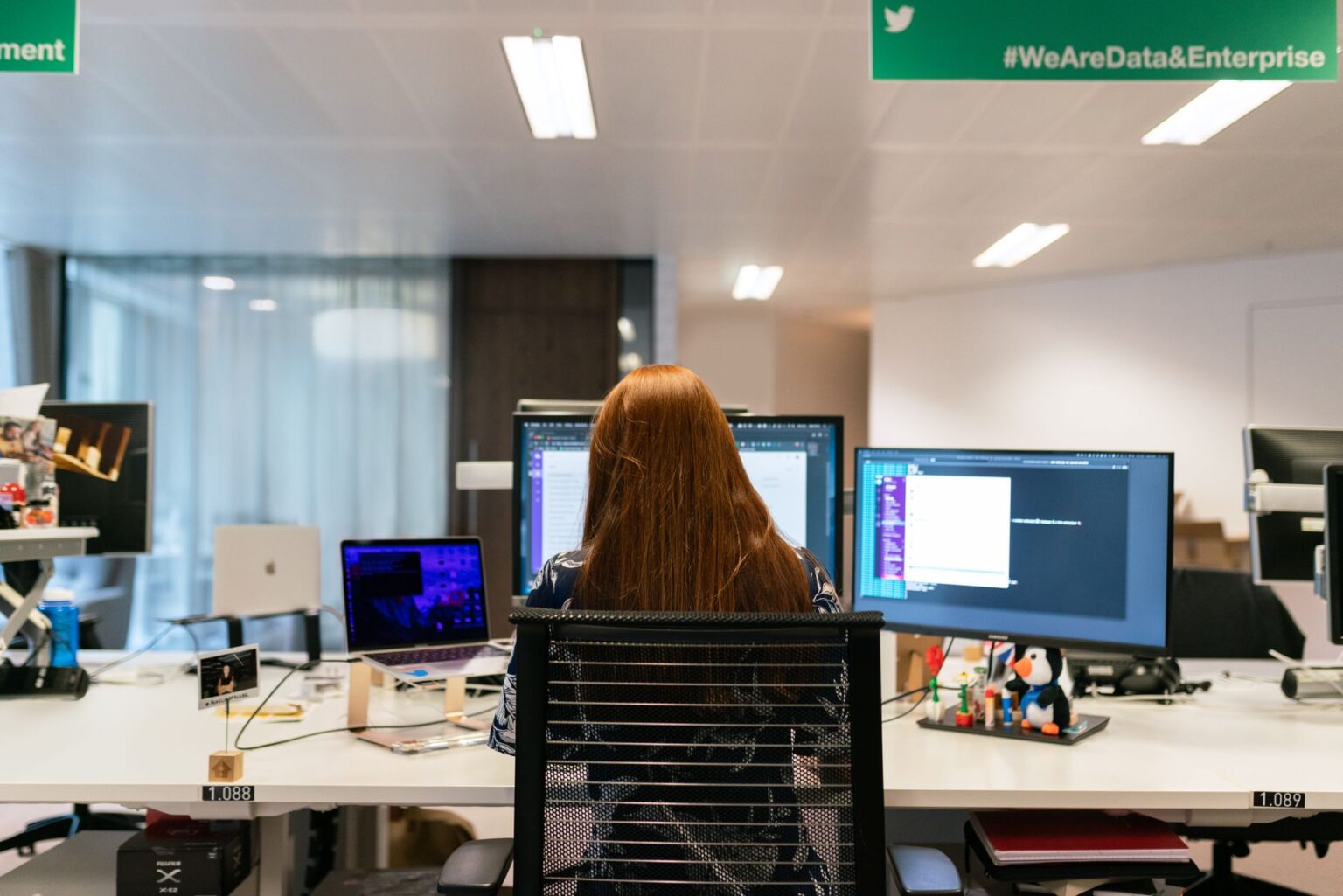 Person working on a productivity app on a laptop at a modern desk