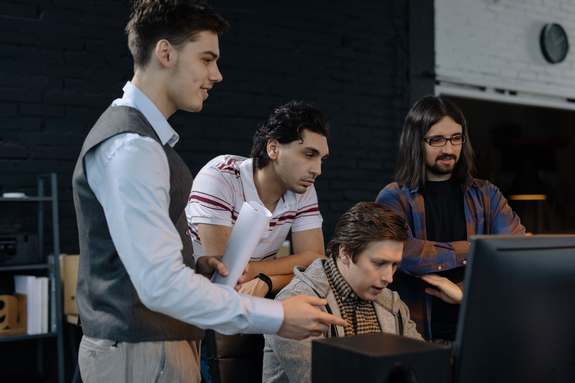 Small startup team working on technology product at shared workspace