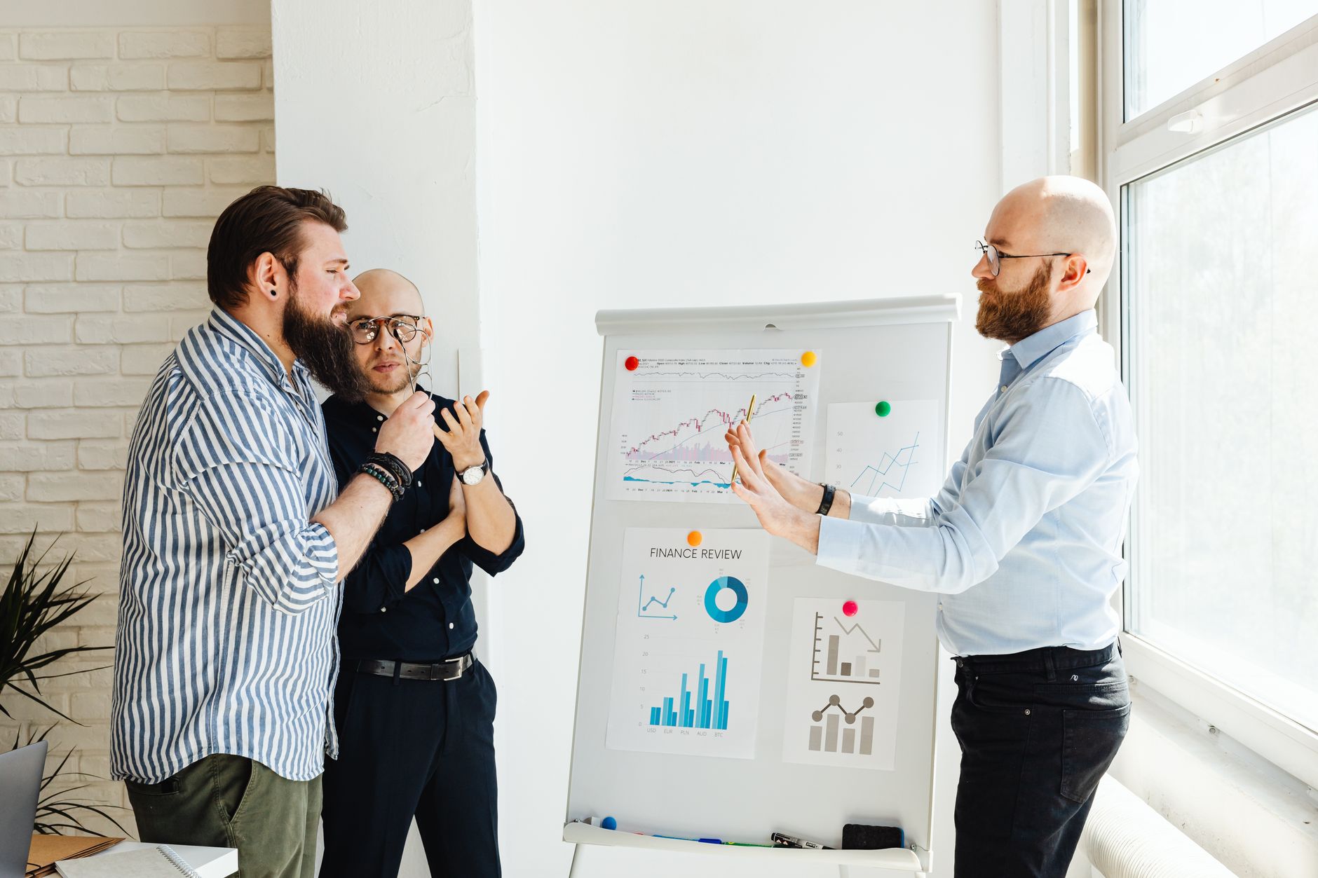 Data team collaborating around analytics dashboards in an open office