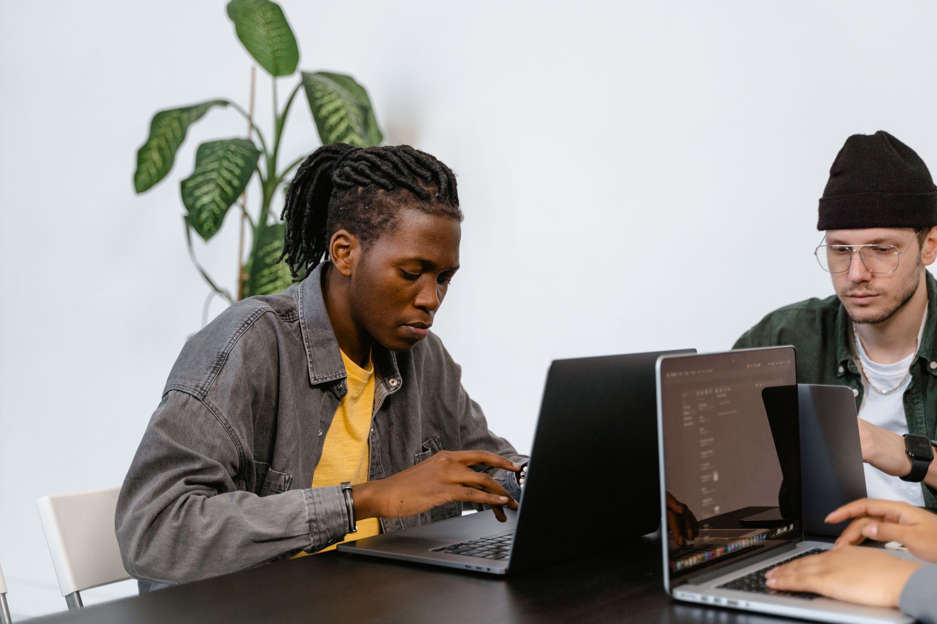 Small startup team working on a product build around a laptop