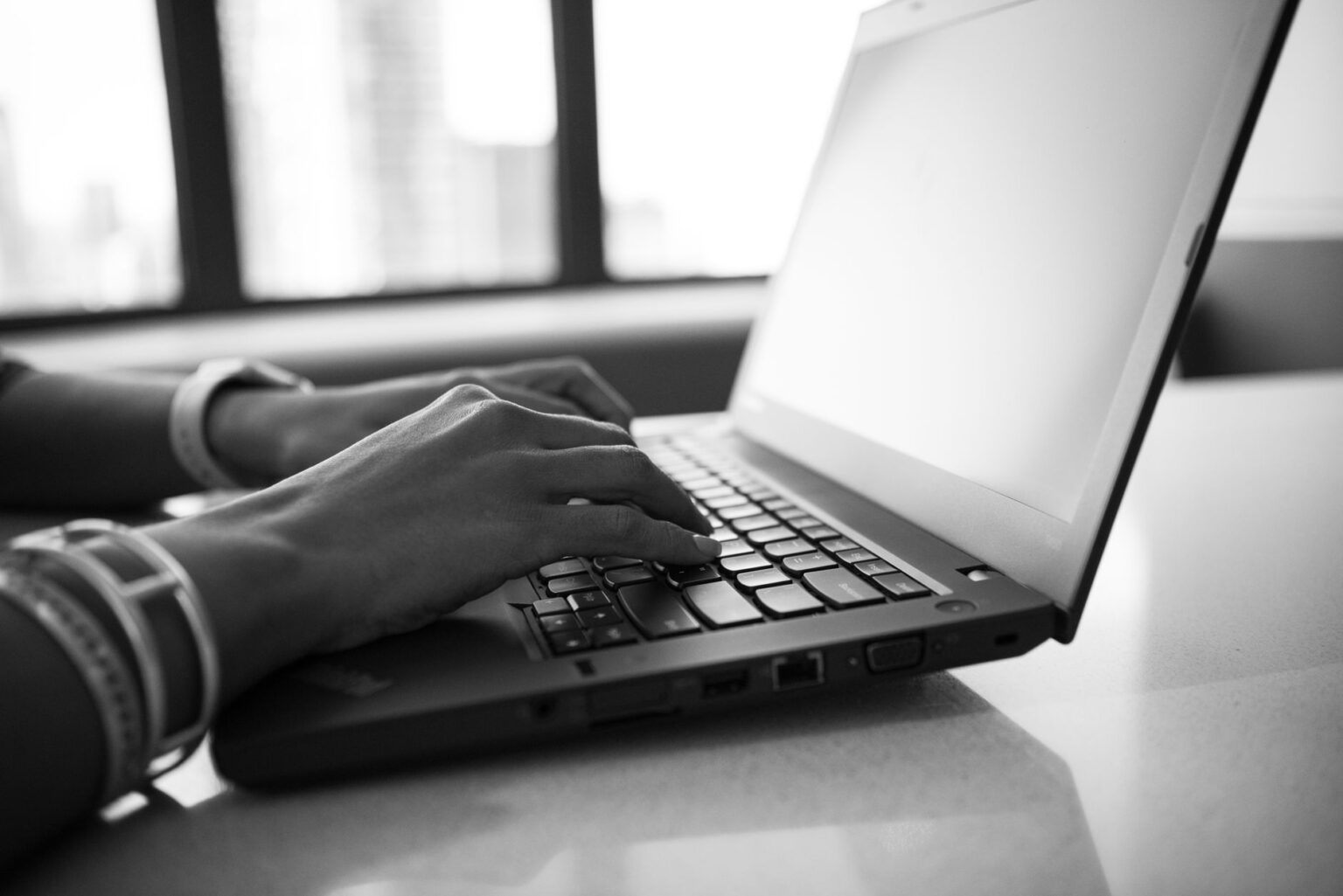 Grammarly’s AI Writing Push Is Bleeding Into Notion’s Creator Base A person typing on a laptop, representing an AI-assisted writing workflow