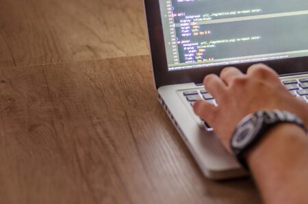 Developer working on a laptop building API integrations for a startup project