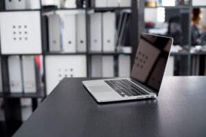 Person working on a laptop with a structured database interface on screen