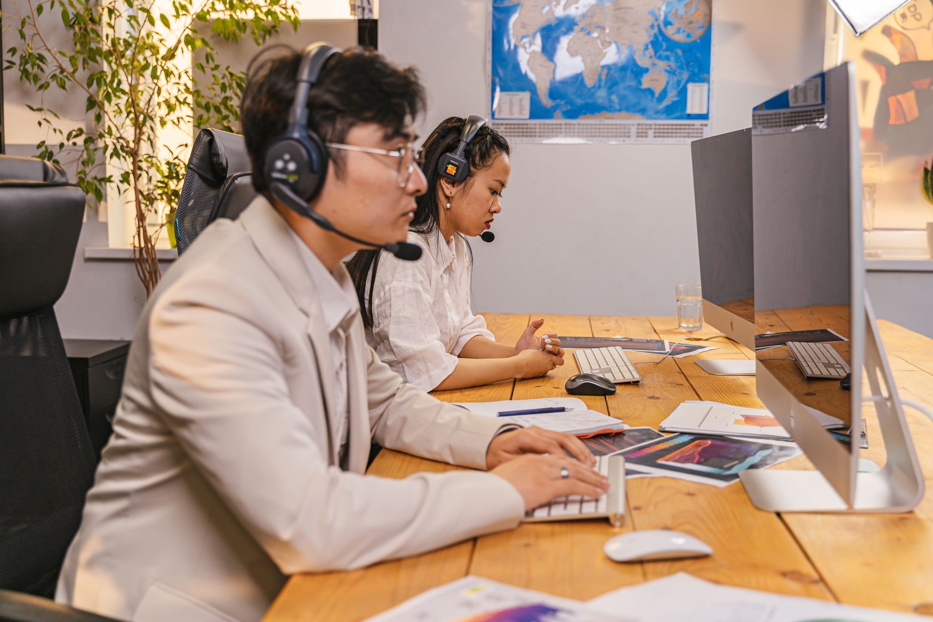 Customer support agent working at a desk with a computer and headset