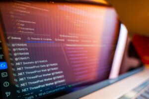 A laptop screen displaying web application code, representing AI-assisted app development