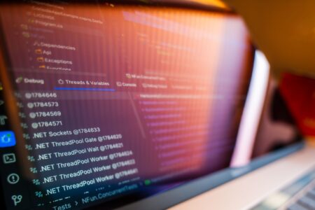 A laptop screen displaying web application code, representing AI-assisted app development
