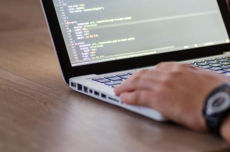 Developer working on a laptop building a web application