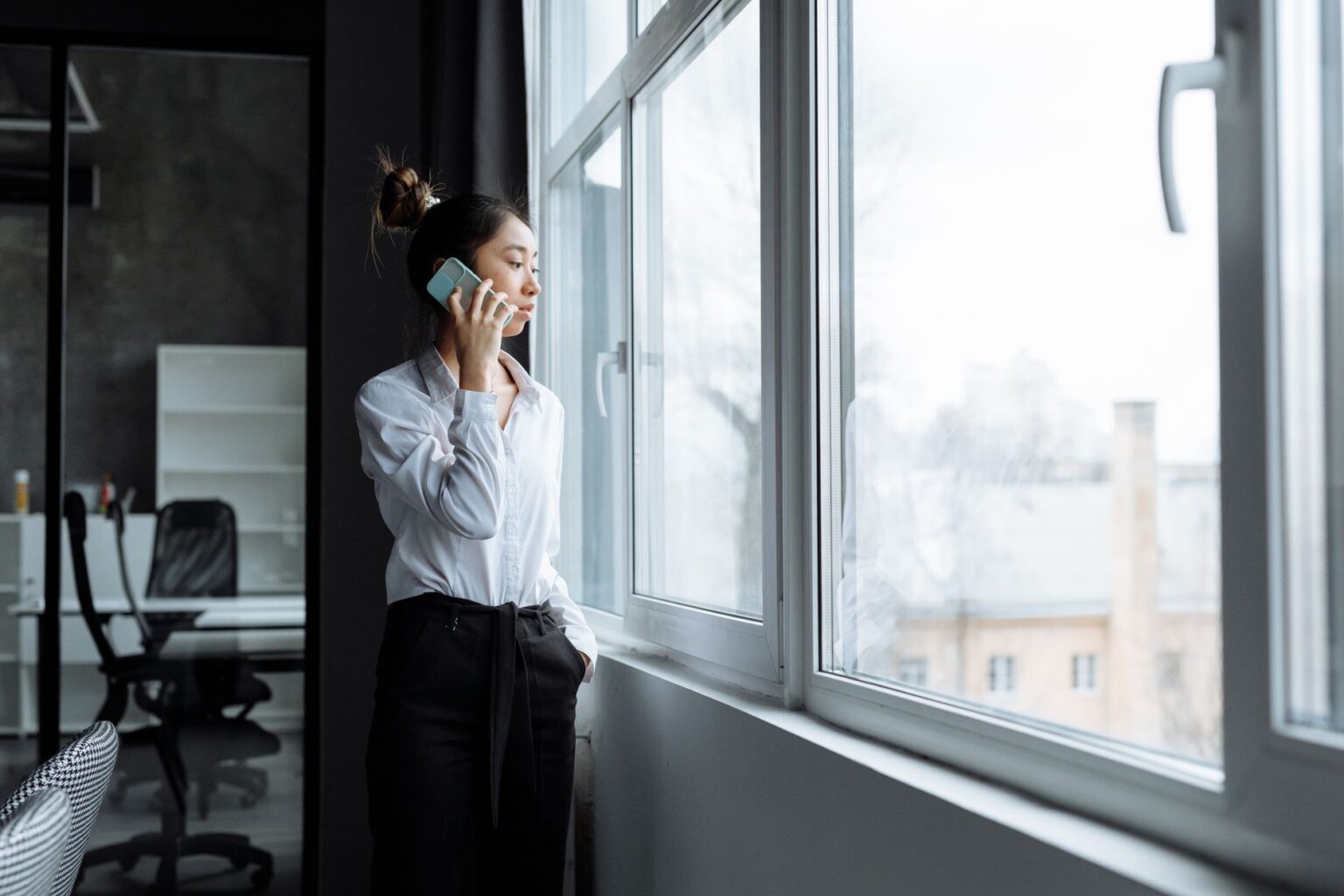 Bland AI’s Voice Agent Platform Is Squeezing Twilio’s Programmable Voice Base A professional on a phone call at a modern office desk representing AI voice technology