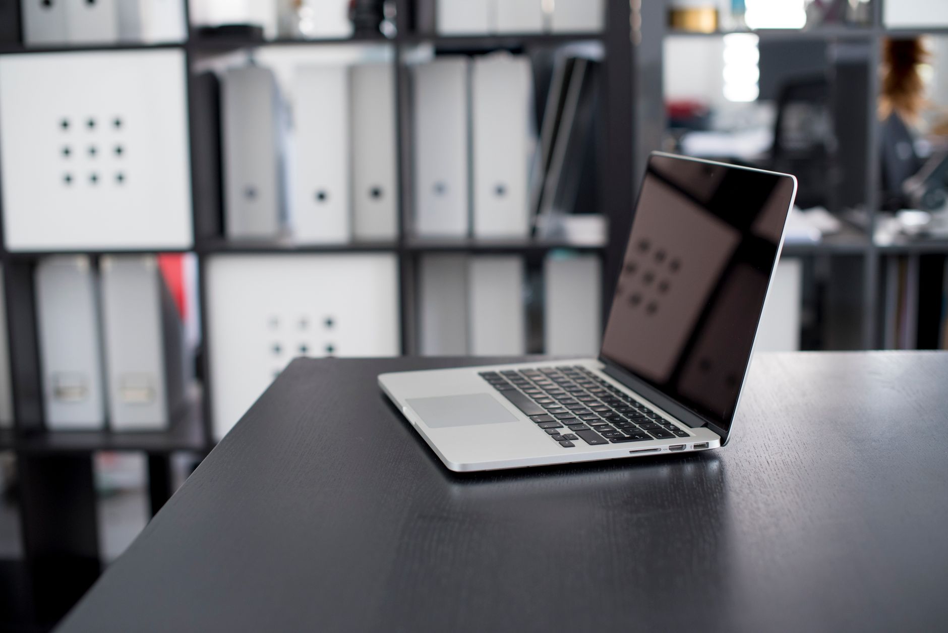 A clean office desk setup with a computer monitor showing a productivity workflow environment