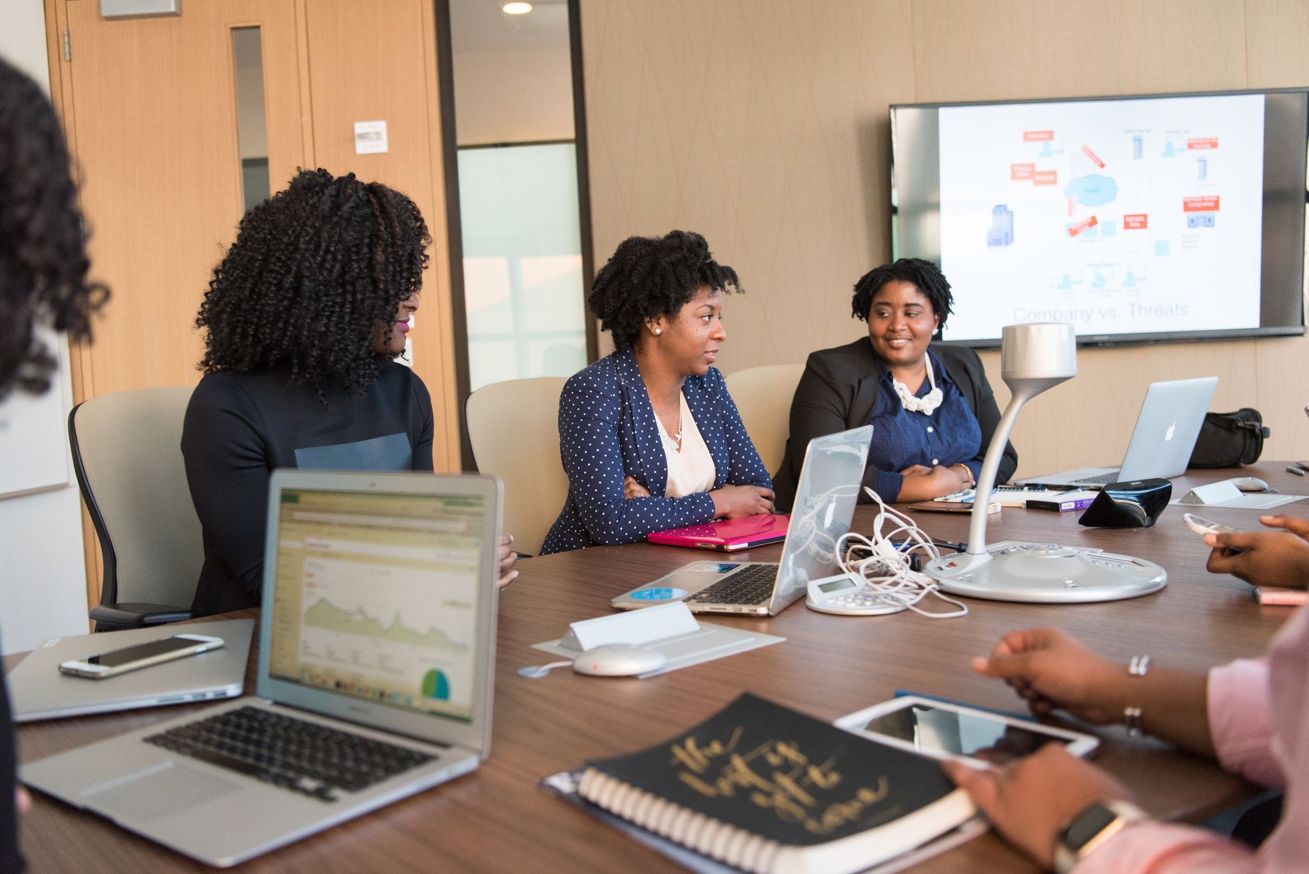 Business professionals reviewing software dashboards during an enterprise technology meeting