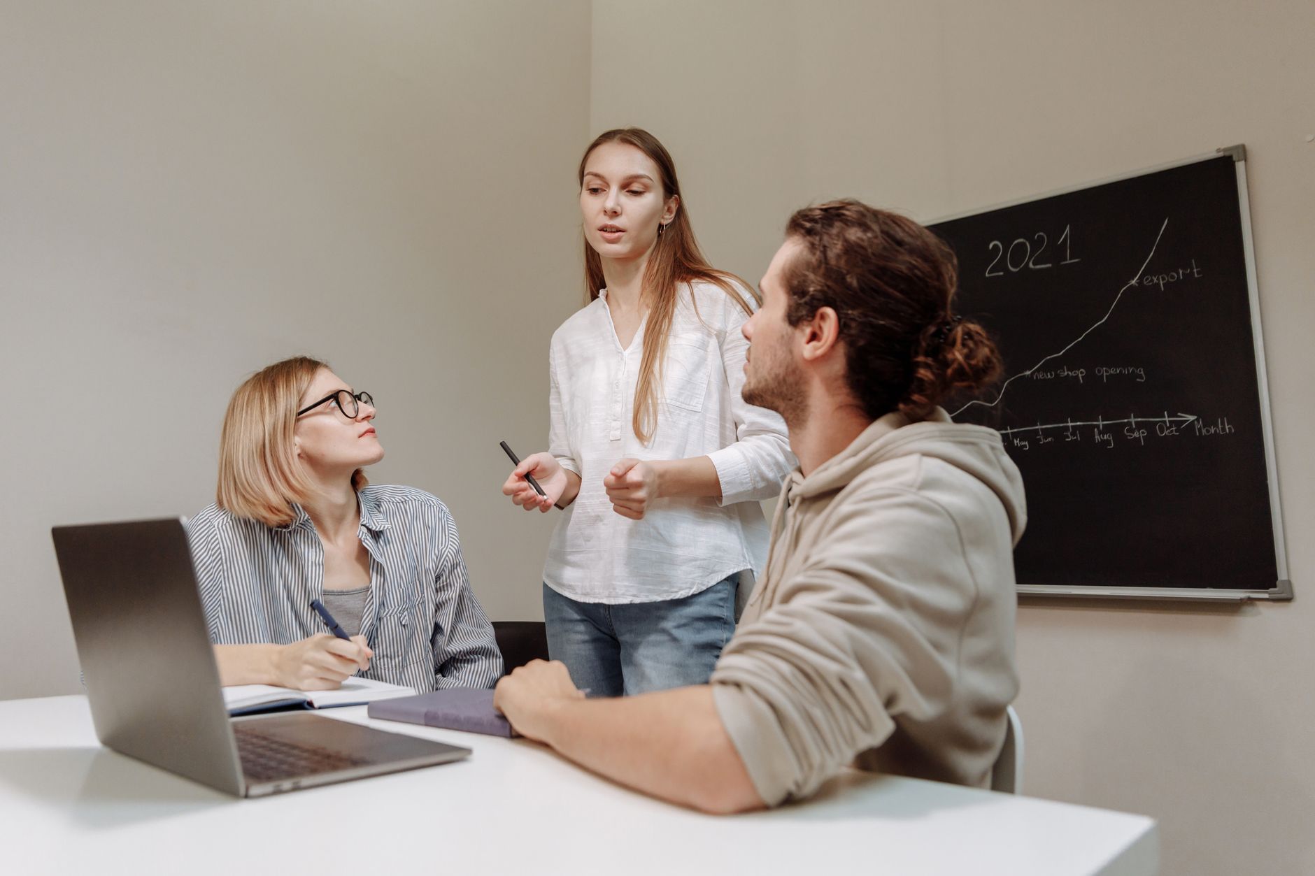 Small startup team discussing product decisions around a table