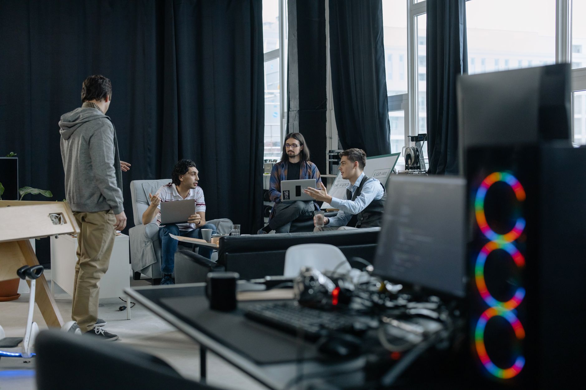 Open-plan startup office with team members working at desks, representing the AI tooling industry