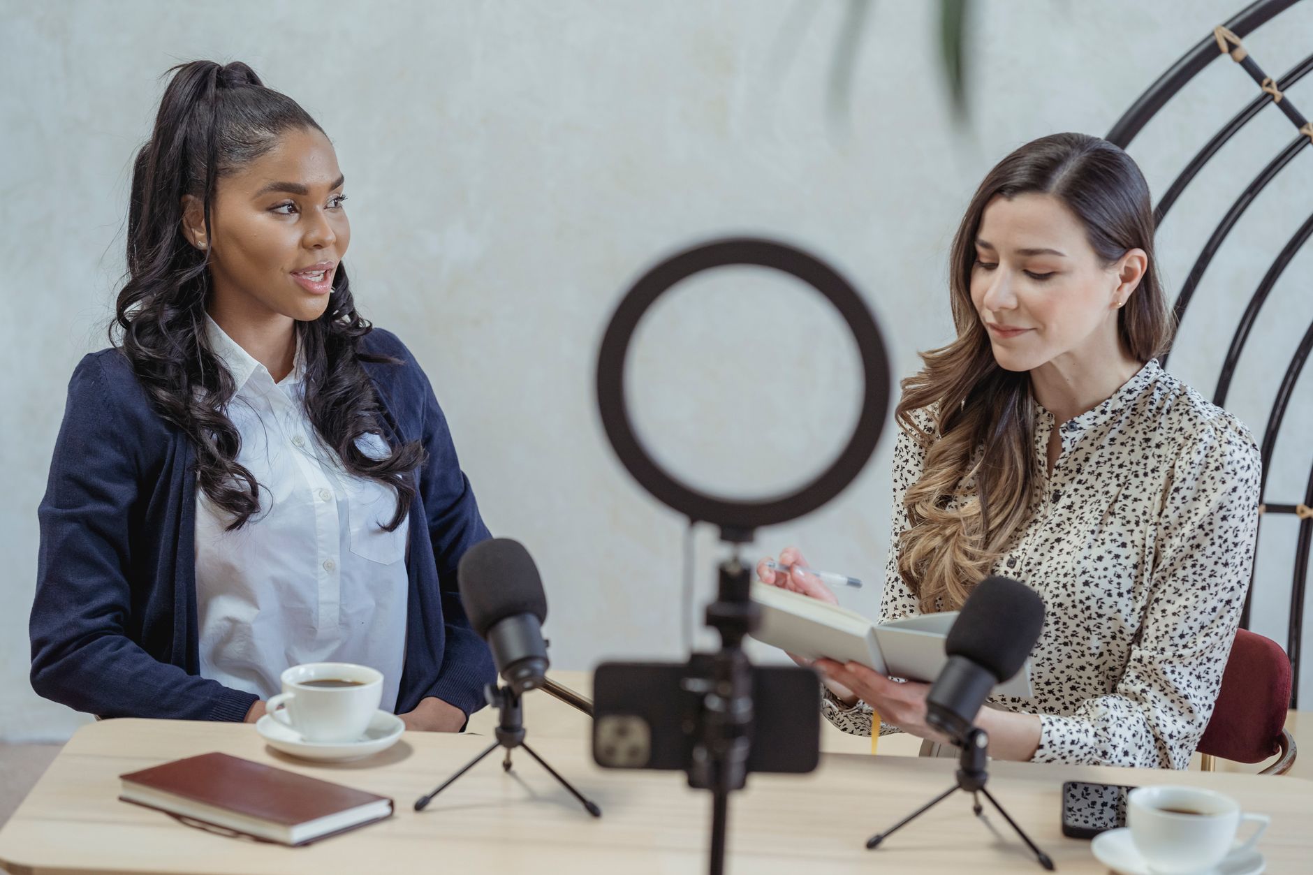 A solo content creator speaking into a microphone at a home studio desk