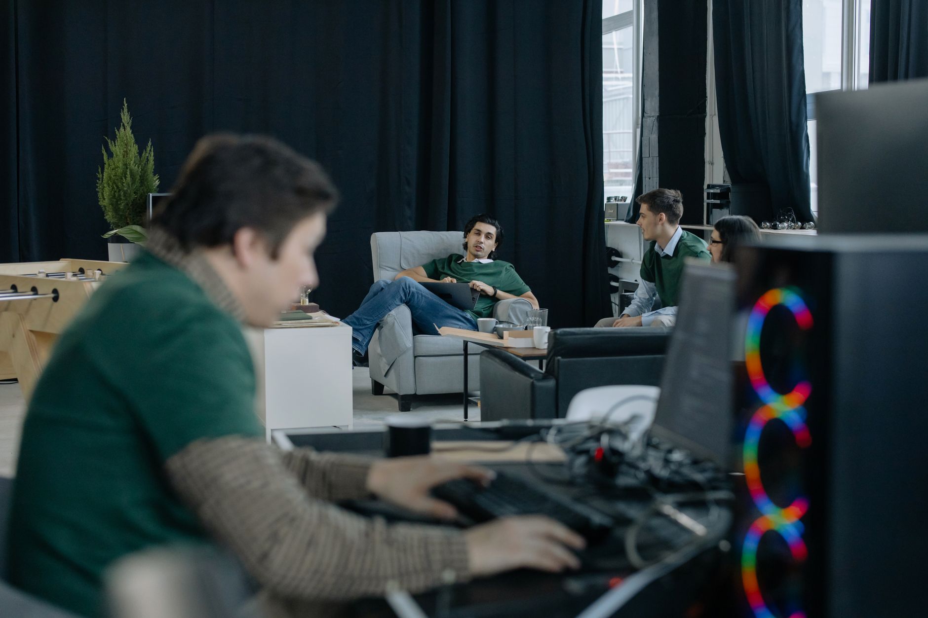 Open-plan startup office with employees working at computers