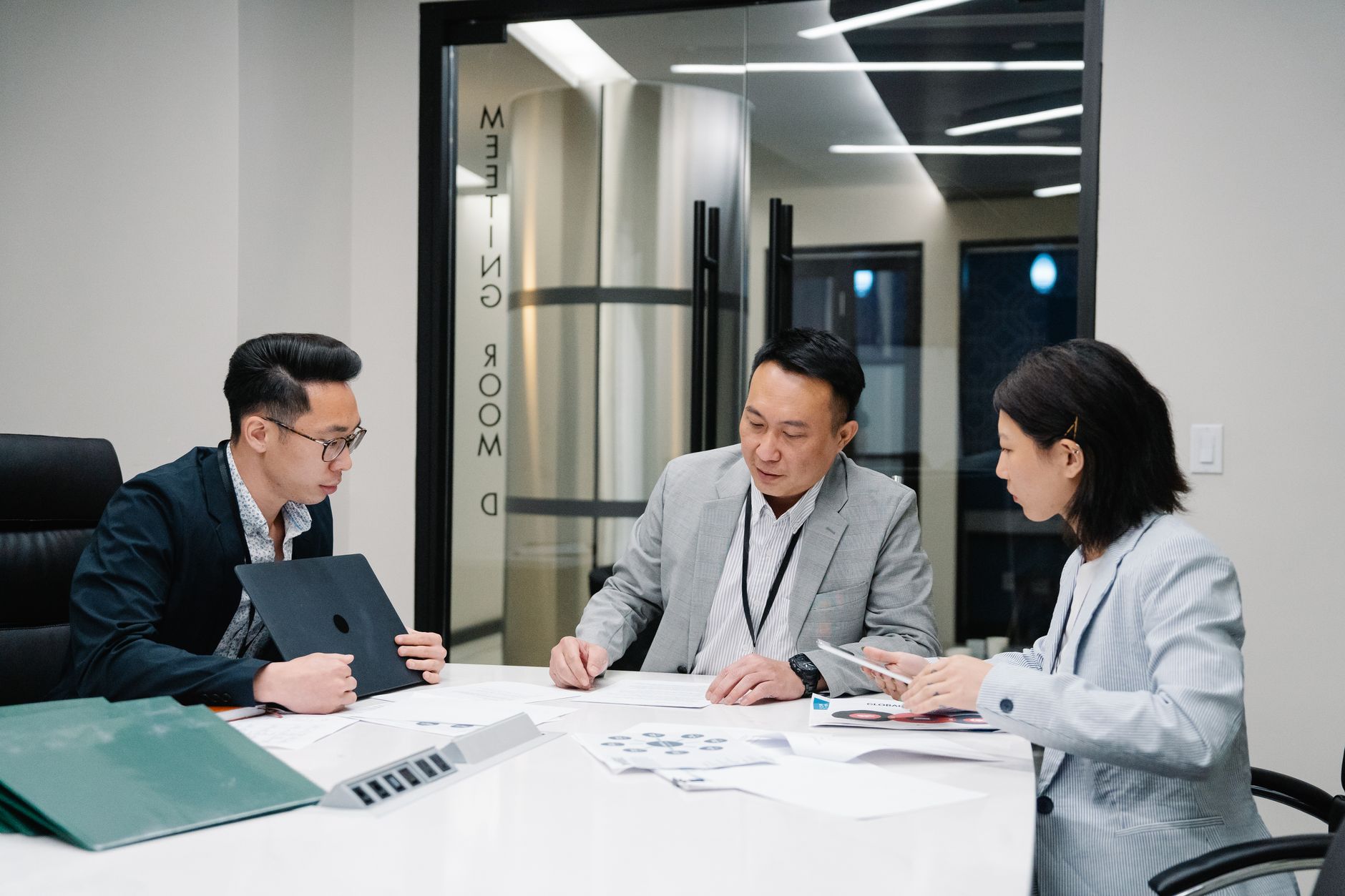 HR team members collaborating around a conference table during a performance review discussion