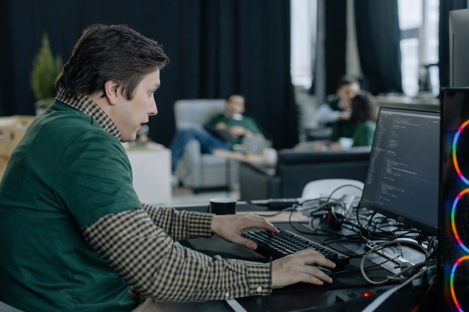 Linear’s Project Tracking Layer Is Quietly Cornering Jira’s Dev Base Software developers collaborating around monitors in a modern open office
