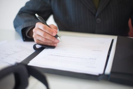 Vanta’s Compliance Automation Is Quietly Cornering Drata’s Mid-Market Base Business professional reviewing compliance documentation at a desk