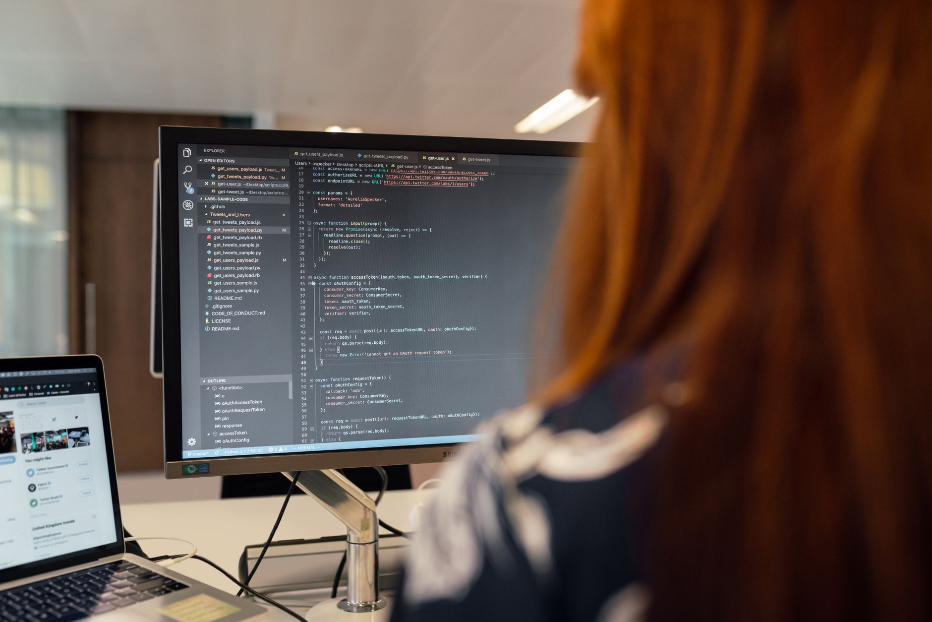 Developer writing code on a laptop screen with dark interface