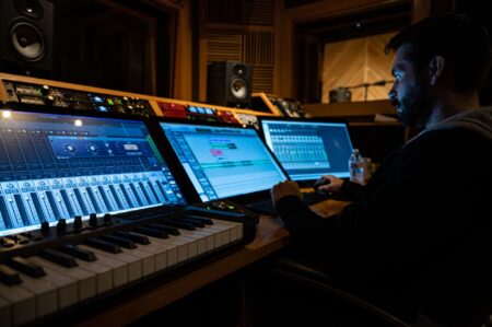 Person recording a screen tutorial at a modern desk setup