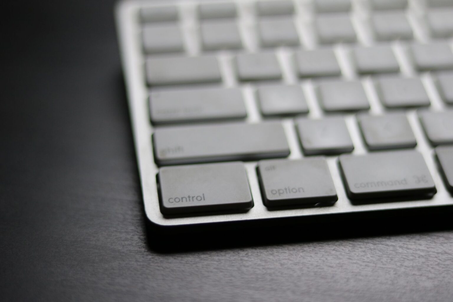 A clean Mac desk setup with keyboard, representing keyboard-driven productivity tools