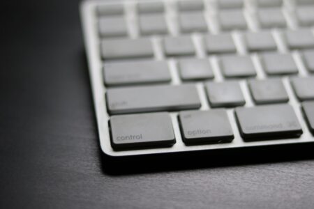 A clean Mac desk setup with keyboard, representing keyboard-driven productivity tools