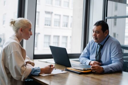 Mercor’s AI Hiring Layer Is Quietly Undercutting Lever’s ATS Base Two people sitting across a desk during a job interview in a modern office setting