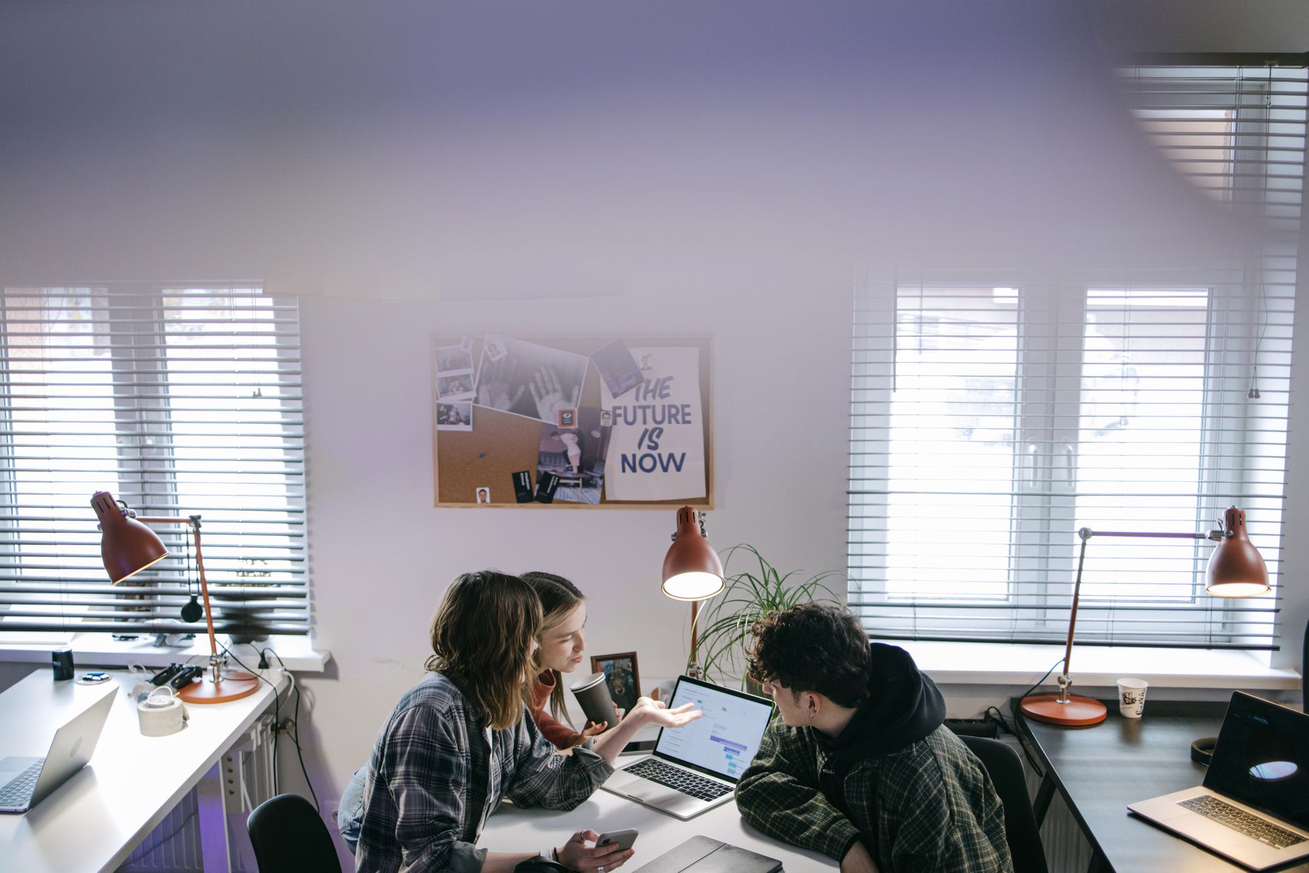 Small team reviewing shared documents in a modern office workspace