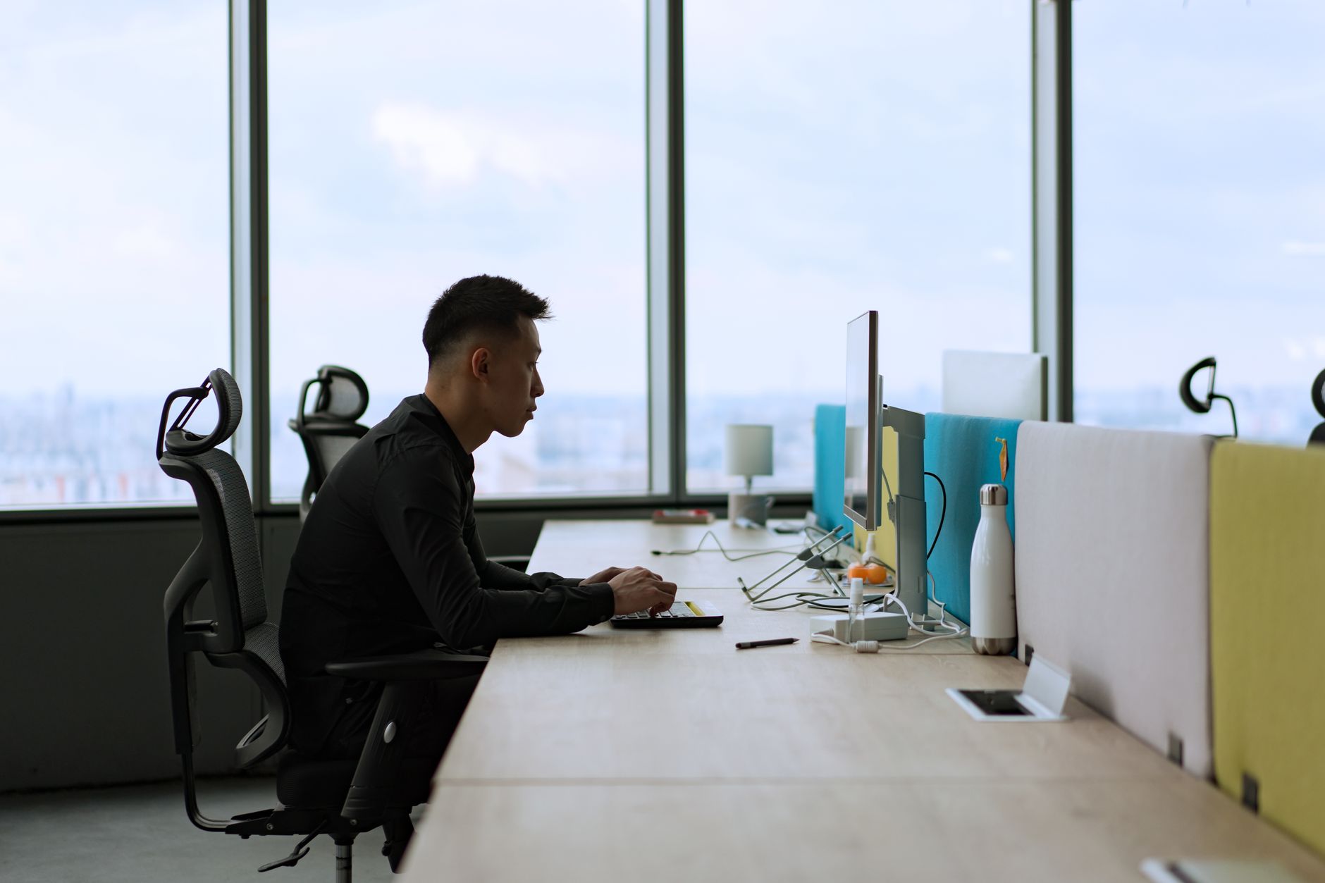 Open plan startup office with team members working at computers